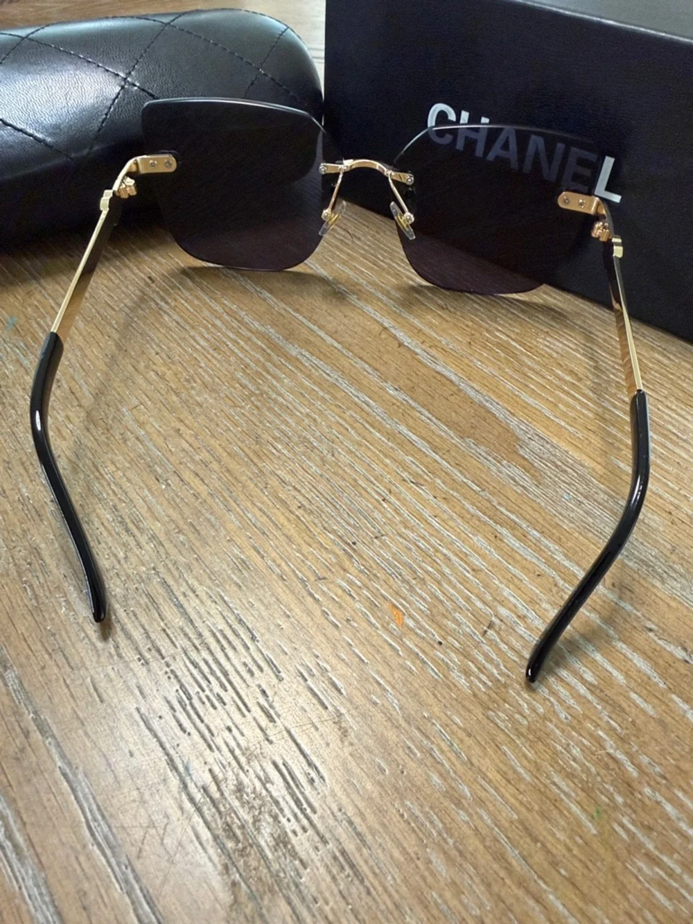 Chanel Women's Black and Gold Rimless Square Sunglasses